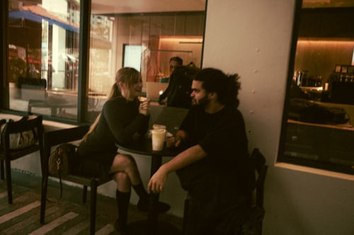 Couple meeting for the first time in Melbourne café after attraction spell