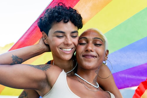 Happy gay couple embracing after successful love spell in Brisbane