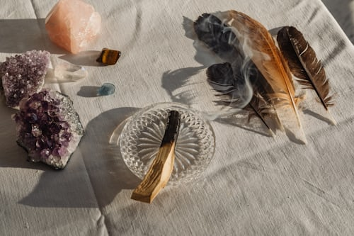 Rainbow candles and rose quartz crystals arranged for same sex attraction spell